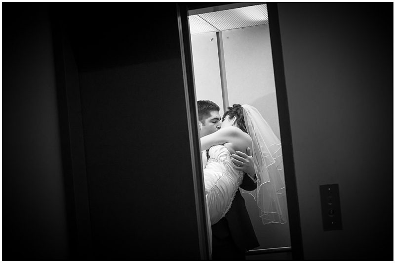 Bride and groom sneaking away in the elevator