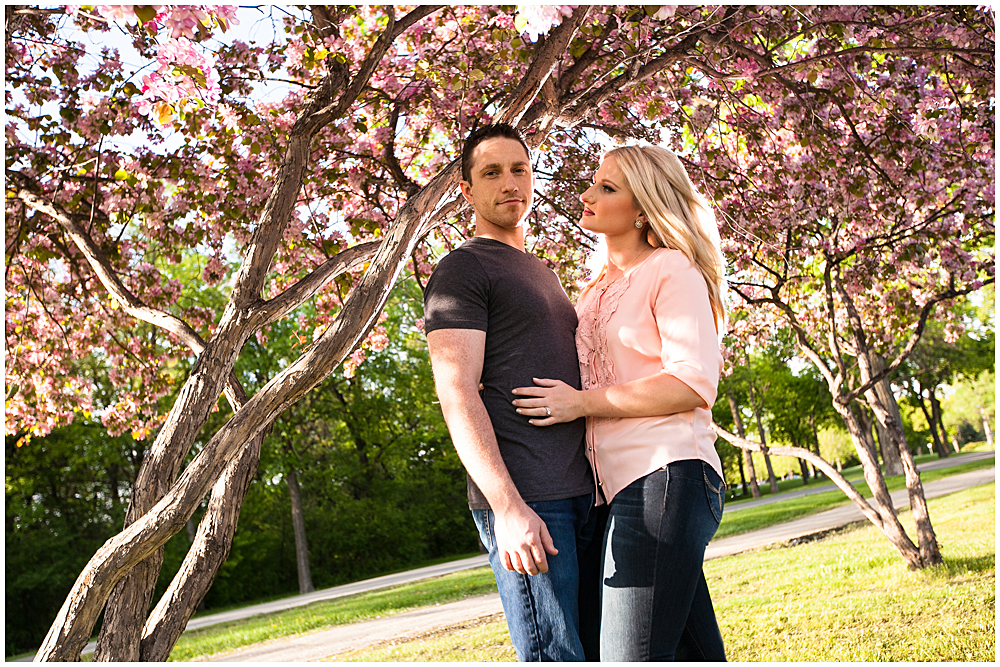 The couple under a beautiful pink tree in the park