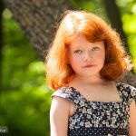 Young red haired girl in the afternoon sun