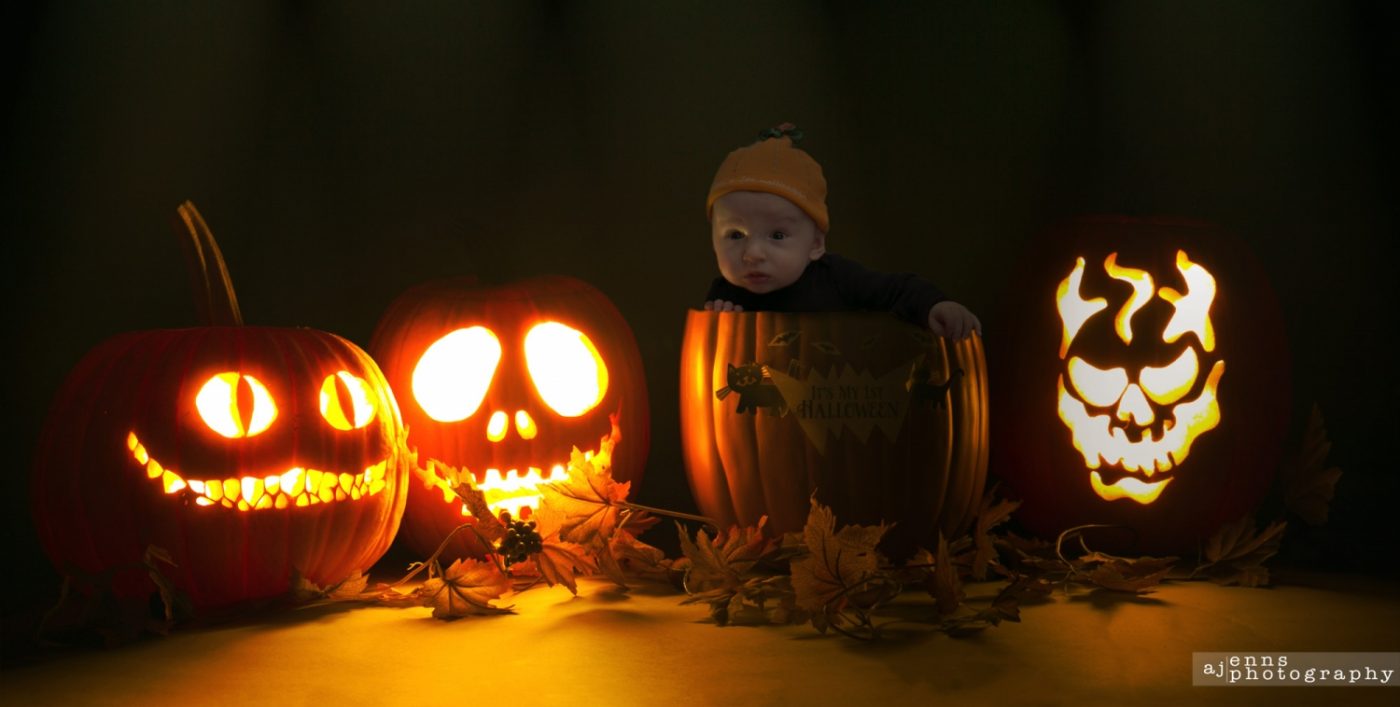 Jaxon sitting in spooky jack o' latern Pumpkins
