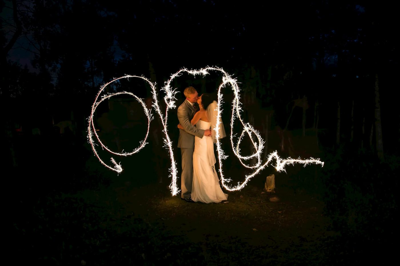Kissing under the sparklers at Pineridge Hollow