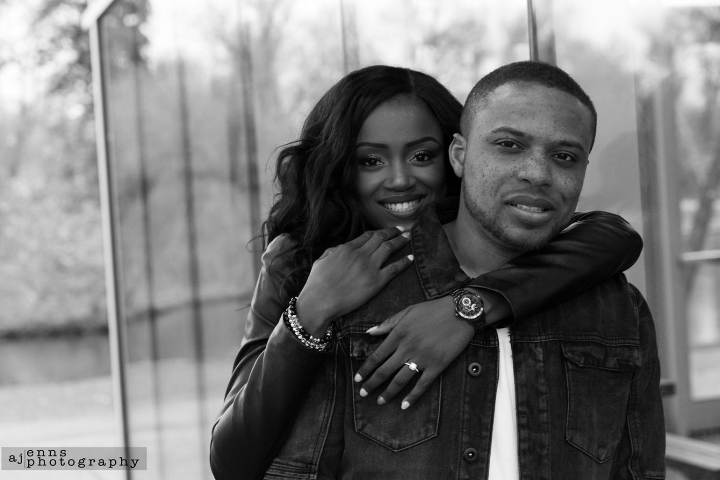 Sandra and Tayo posing by a huge glass wall