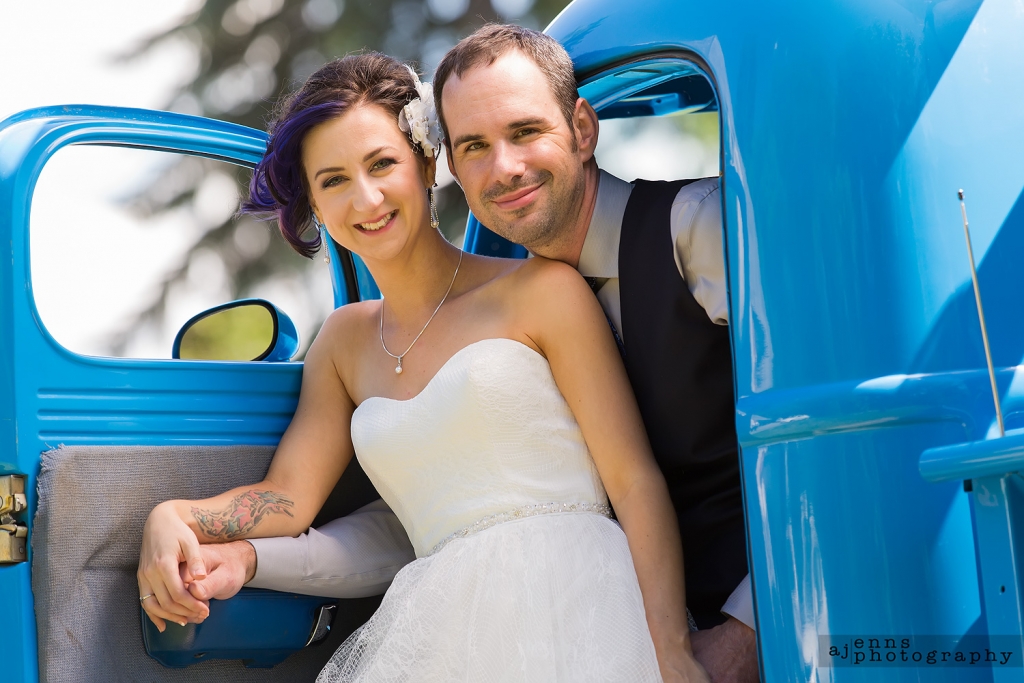 Julie and Darrell in the front seat of the antique blue truck