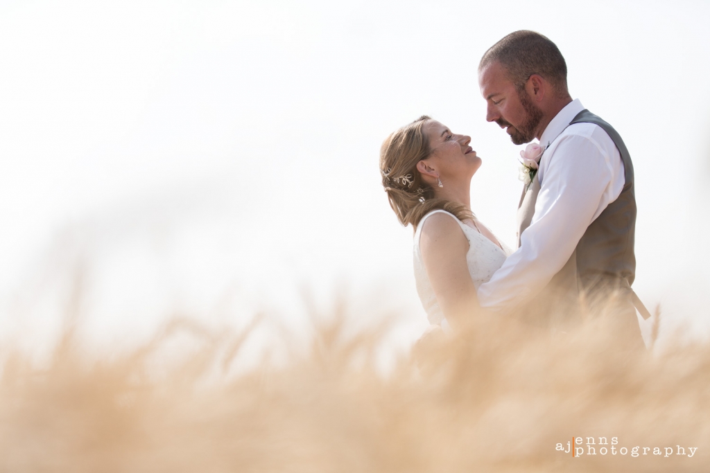 The couple looking into each others eyes in the wheat field