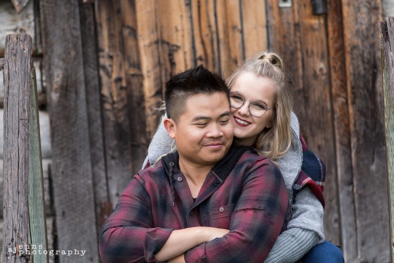 Engagement photos with the girl hugging the guy from behind