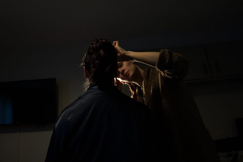 Robyn Getting her makeup put on in a dark silhouette