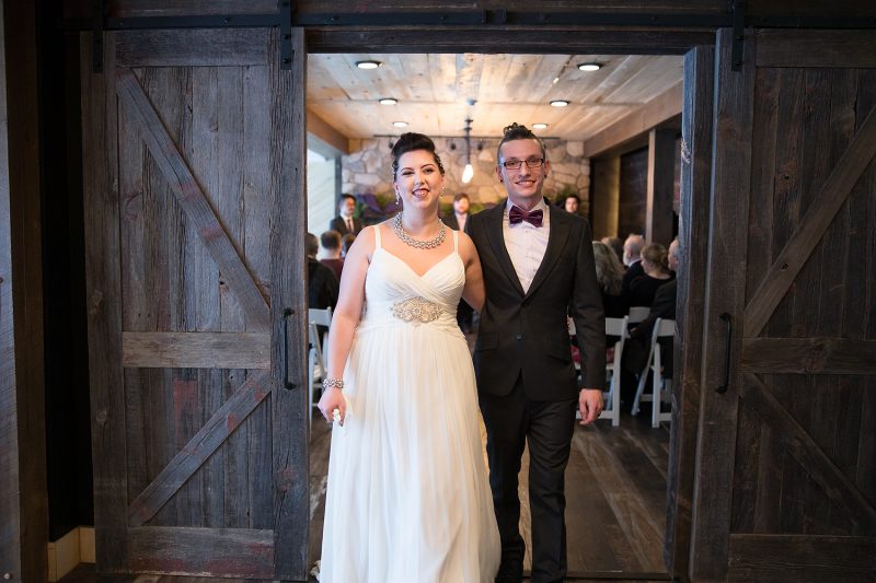 Walking out for the first time as time husband and wife with natural smiles