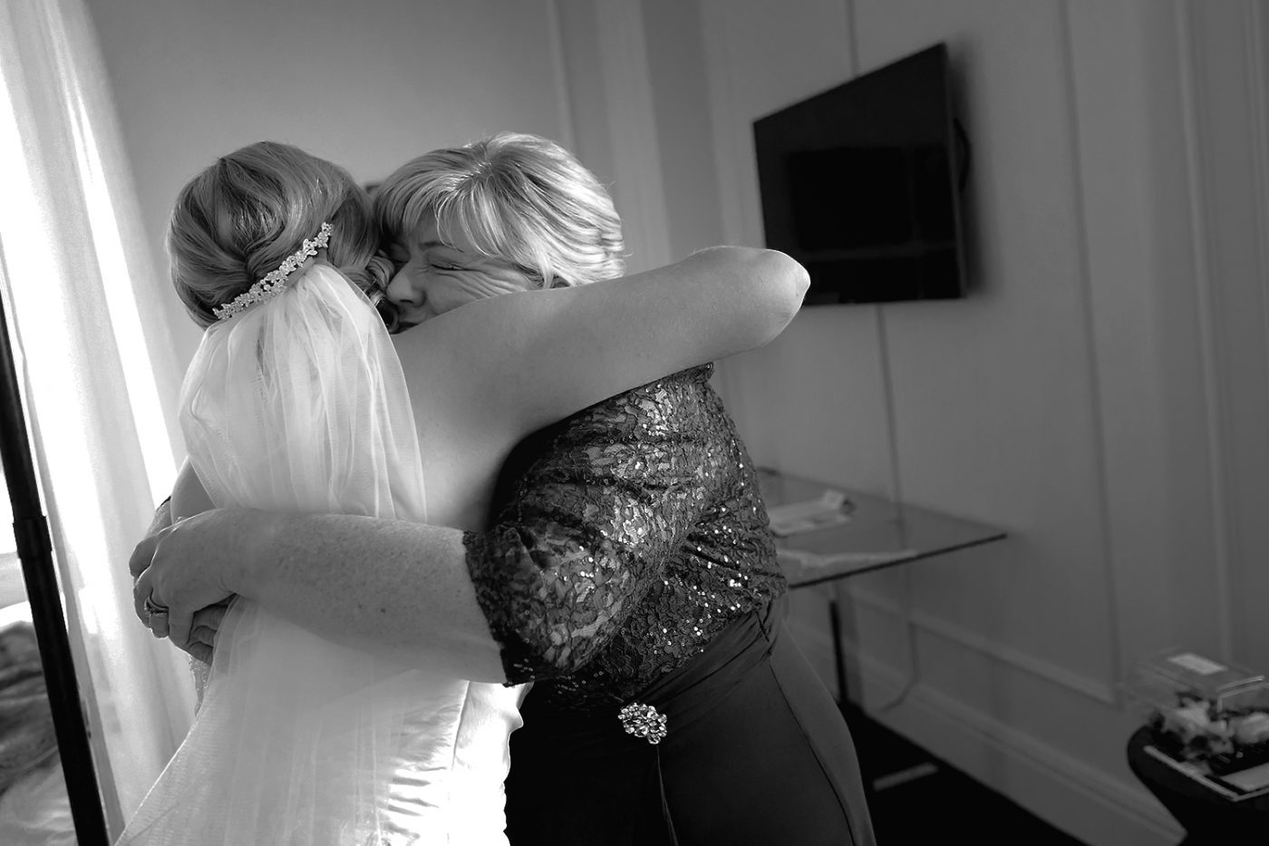 Mother hugging her daughter on the wedding day