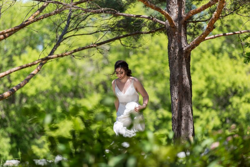 The bride walking through some trees