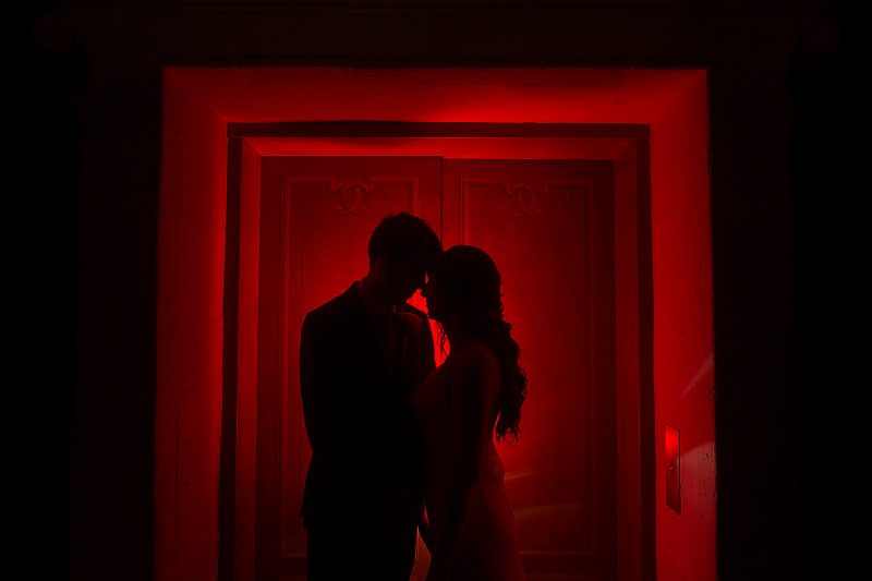 The silhouette of the couple in red light