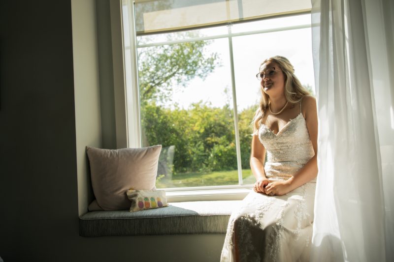 Chynna waiting patiently before the ceremony in a window well