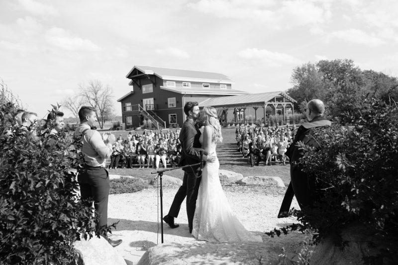 The first kiss with the guests and venue in the background