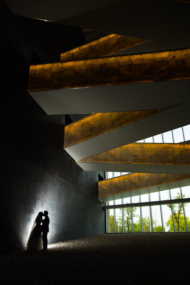 The couple silhouette under the glowing walkways at the CMHR