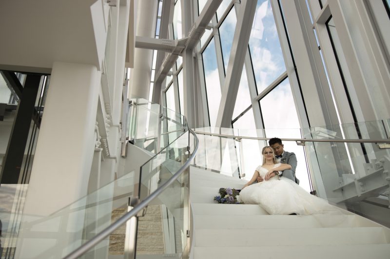 The couple sitting on the stairs at the top of the tower at the Canadian Museum of Human Rights