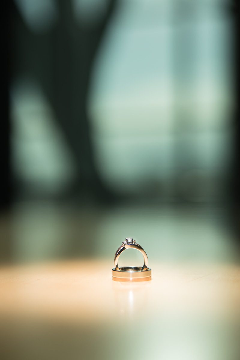 The couples wedding rings on a wooden table