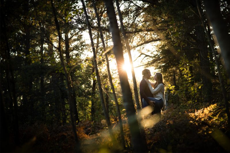 The couple embracing each other in the middle of the bush at sunset
