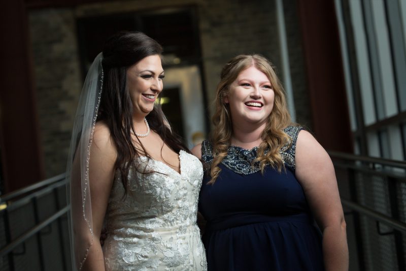 Jenn and her maid of honour on the walkway at the Red River Collage Campus