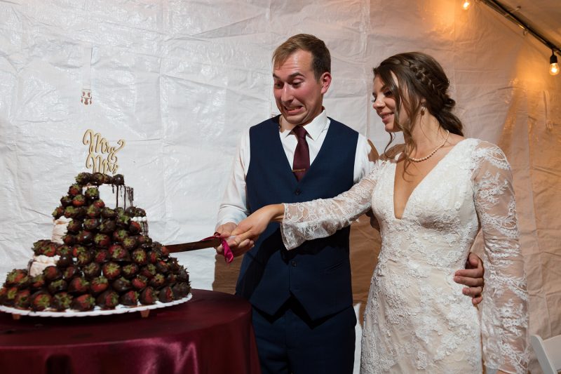 The couple cutting the cake while Brendan makes a funny face of fear