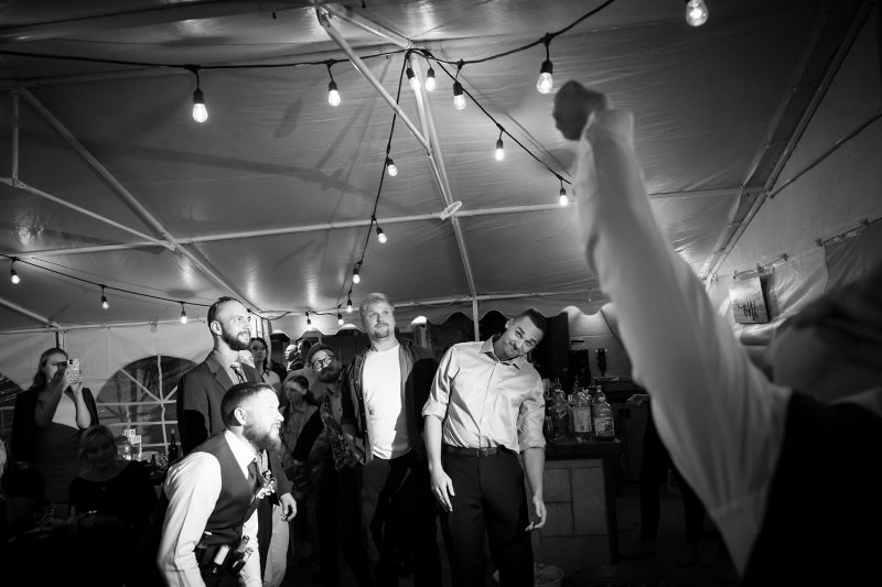 The garter flying through the air while the men avoid it