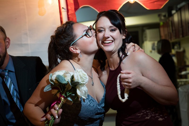 The women kissing who caught the bouquet and garter