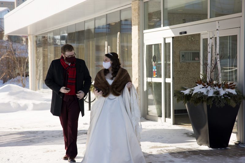 The bride and groom walking out of the Inn at the Forks