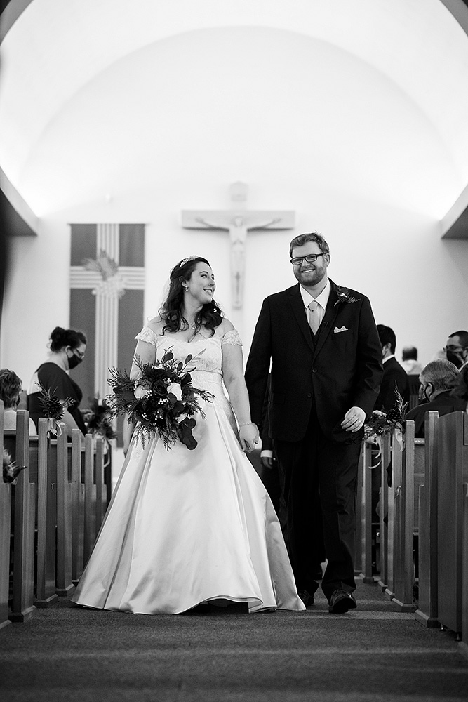 Meaghan and Peter walking out the isle hand in hand