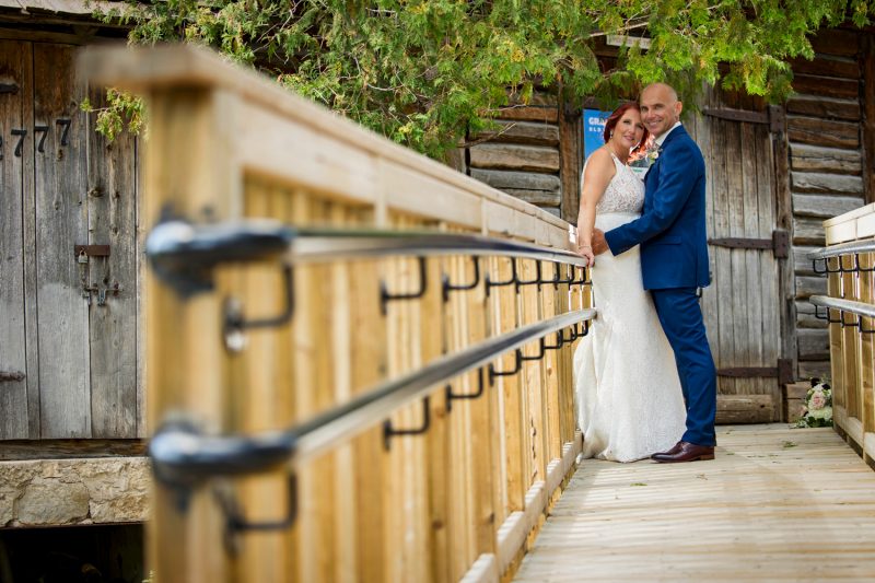 The couple leaning against a railing taking from a low angle with leading lines