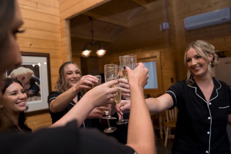 Karlie cheersing her bridesmaids with champagne