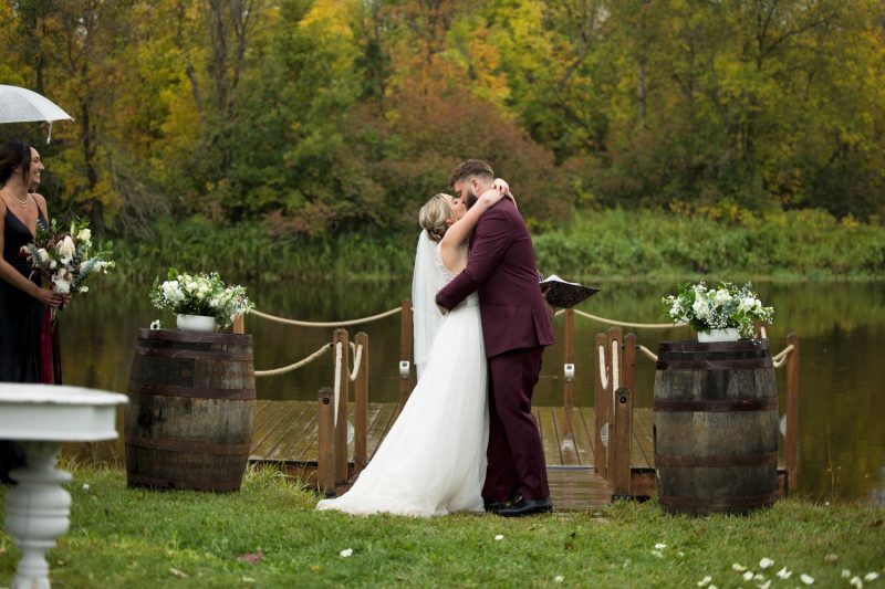 The first kiss in front of the dock at Rivers Edge Resort