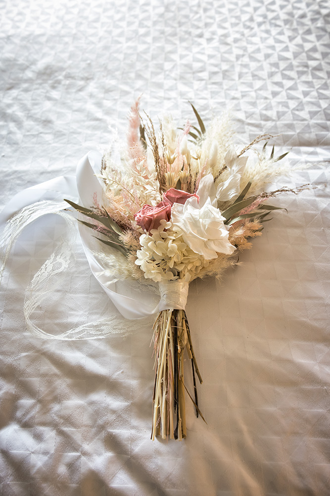 Danielle's wedding bouquet on the bed