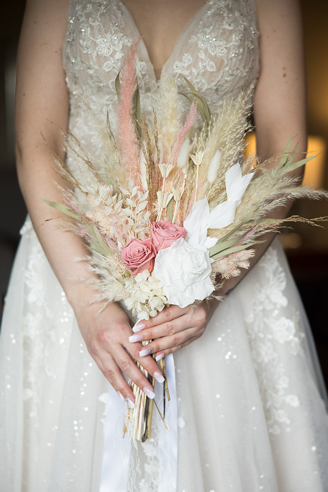 Tight shot of the bride holding her bouquet