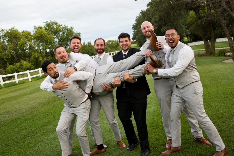 The groomsmen lift up Jon